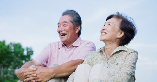 Senior couple outdoors discussing Medicare plans