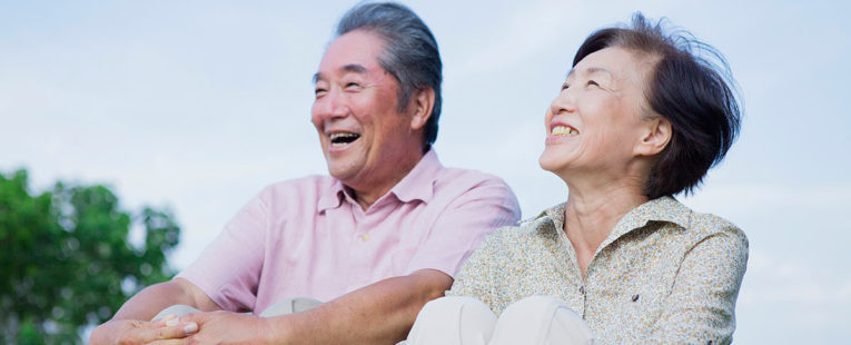 Senior couple outdoors discussing Medicare plans