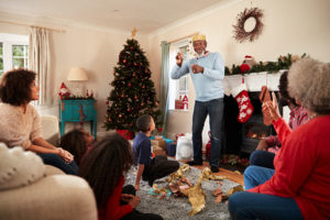 family playing charades at Christmastime