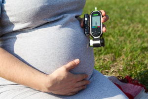 Mom-to-be with gestational diabetes checking blood sugar