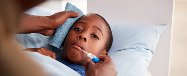 Father comforting his young son with fever