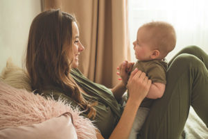 Young mother and infant son in need of pediatrician