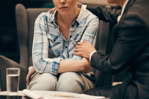 young woman in grief group being consoled