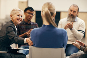 young woman in grief support group sharing story