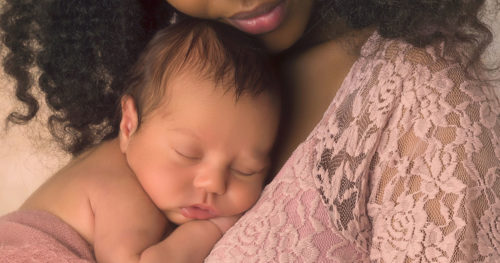Baby sleeping on mother's chest