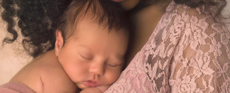 Baby sleeping on mother's chest