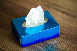 Box of facial tissues on office desk.