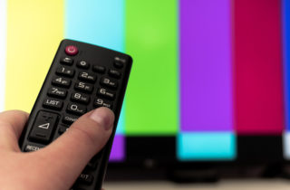 Person watching television news media.