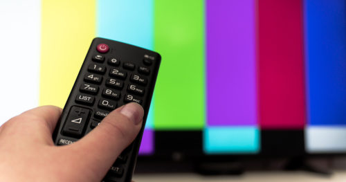 Person watching television news media.