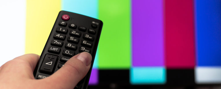 Person watching television news media.