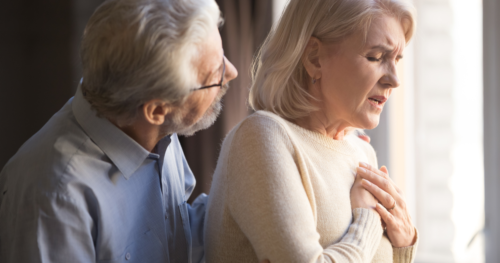 man helping woman with shortness of breath