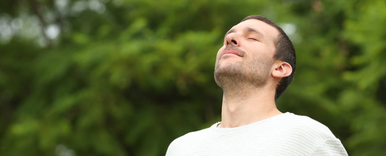 Young man with asthma practicing breathing exercises.