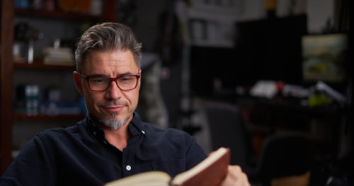 Middle-aged male reading about mental health.