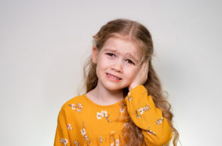 Young girl with ear infection.