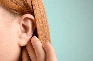 Young woman with ear infection.
