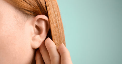 Young woman with ear infection.