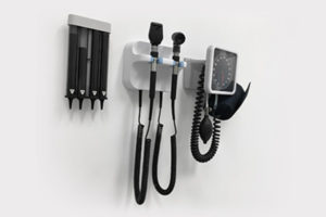 Otoscope hanging on wall in health care provider's office