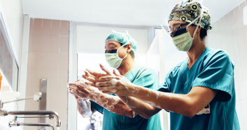 Two surgeons washing hands prior to elective surgery