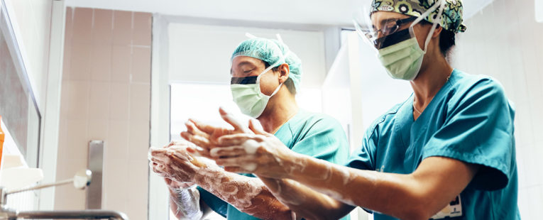 Two surgeons washing hands prior to elective surgery