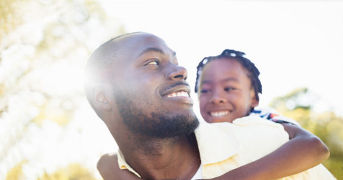African-American father with daughter after receiving vaccine