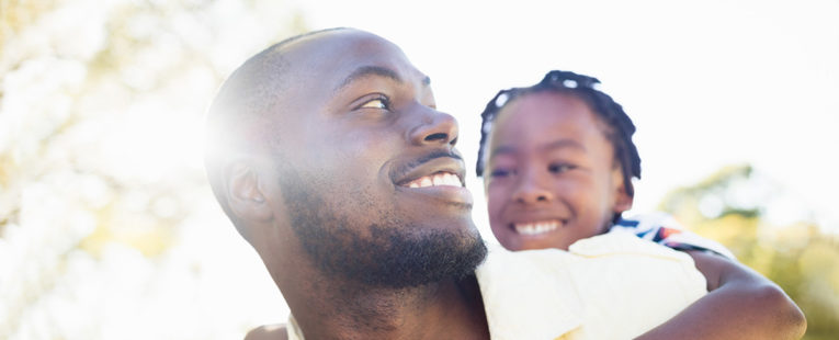 African-American father with daughter after receiving vaccine
