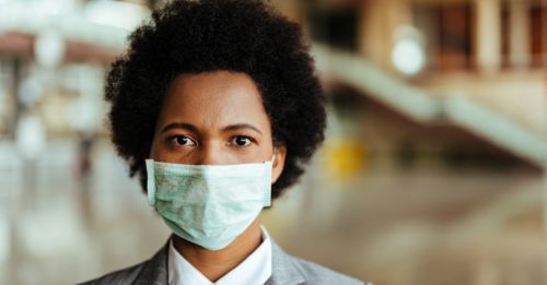 serious business woman wearing a mask