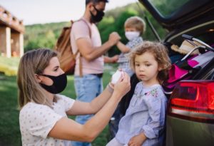 family of four preparing for outside activities and wearing their masks