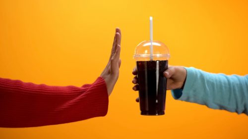 one hand offers another a soda while the other gesture rejection