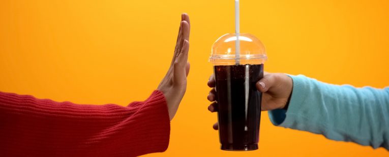 one hand offers another a soda while the other gesture rejection