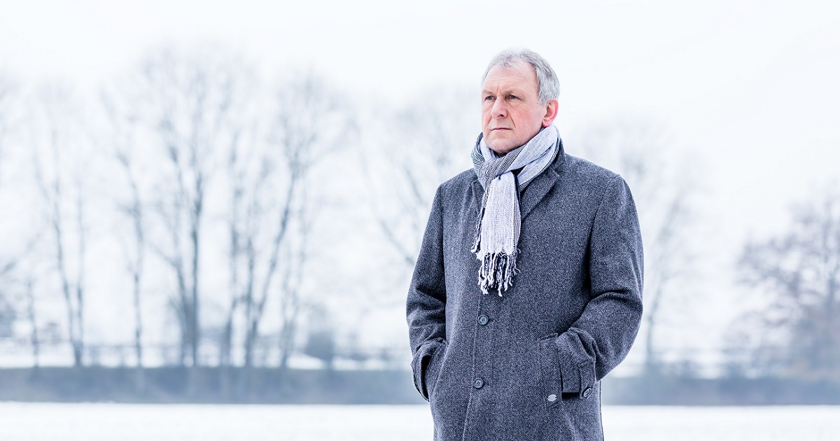https://osf-blog.live.imagescape.com/blog/wp-content/uploads/2020/11/senior-man-stands-solemnly-outside-in-a-coat-and-scarf-during-winter.jpg