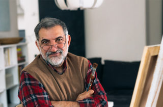 Middle-aged man in artist studio considering lung cancer screening.