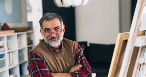 Middle-aged man in artist studio considering lung cancer screening.