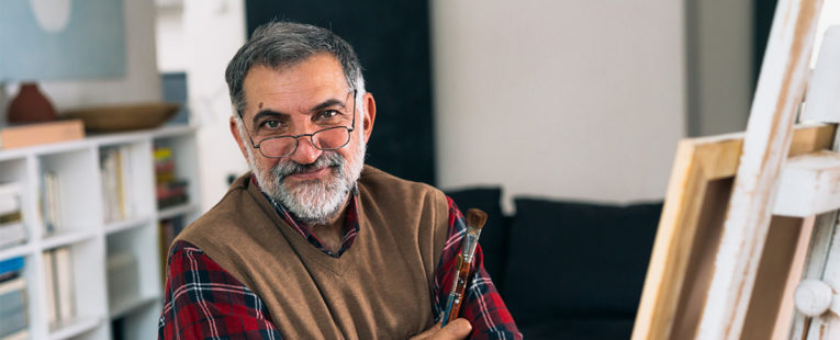 Middle-aged man in artist studio considering lung cancer screening.