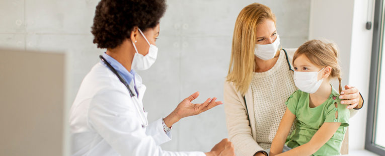 Primary Care Provider consulting a woman patient and her toddler daughter.