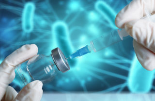 needle pulling a vaccine from a vial