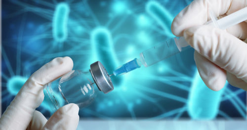 needle pulling a vaccine from a vial