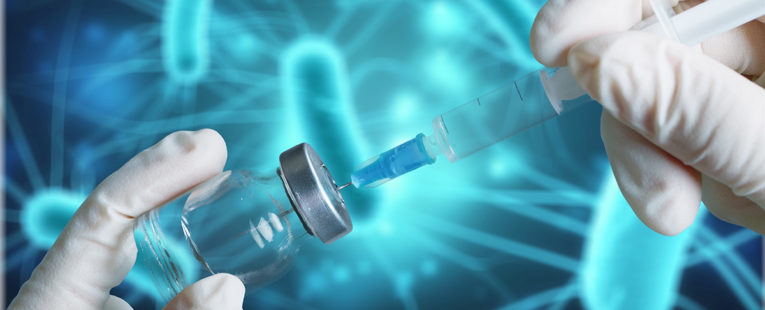 needle pulling a vaccine from a vial