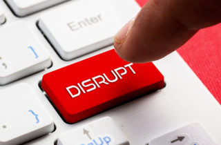 person presses a red disruption button on a keyboard