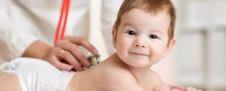 A doctor performs a newborn screening on a young baby.