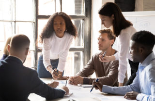 a group of professionals have a business discussion over a table