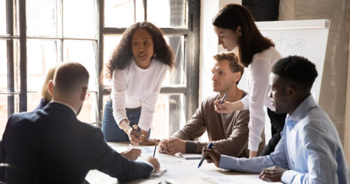 a group of professionals have a business discussion over a table