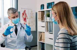 Provider and patient consult during annual checkup.