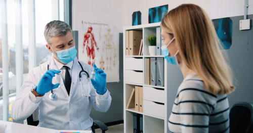 Provider and patient consult during annual checkup.