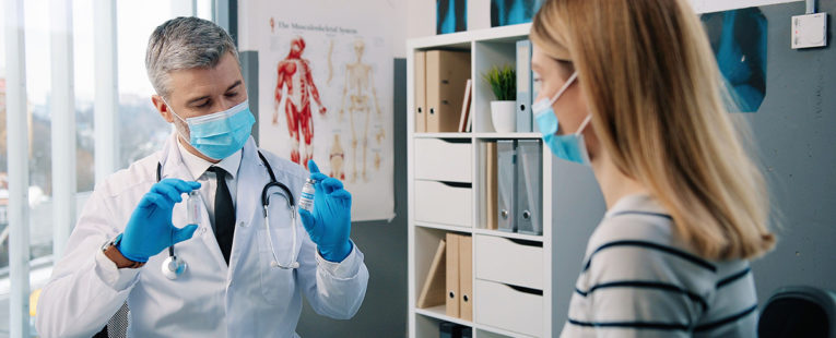 Provider and patient consult during annual checkup.
