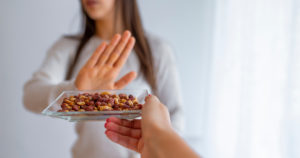 woman turning away food