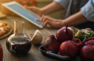 woman looks at a recipe on a tablet in the kitchen