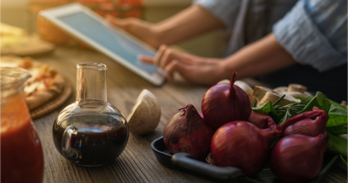 woman looks at a recipe on a tablet in the kitchen