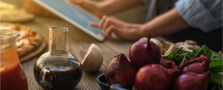 woman looks at a recipe on a tablet in the kitchen