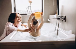Child taking a bath with his mom