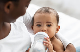 why do babies spit up